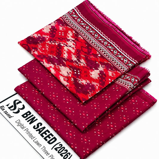 Three folded fabric pieces in a stacked arrangement on a white background, with a printed paper label at the bottom left reading '53 BIN SAEED Digital Printed Lawn Three Piece'. The top fabric has a red, pink, and cream geometric pattern with a decorative border; the middle and bottom fabrics are solid deep pink with small white dot prints.