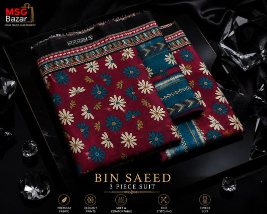 A 3-piece suit set from MSC Bazar named 'Bin Saeed', featuring a deep red kurta with cream and blue floral prints, paired with teal and navy patterned trousers. The set is styled in a luxury black presentation box with decorative black silk fabric and clear crystal props, with product details and features displayed at the bottom.