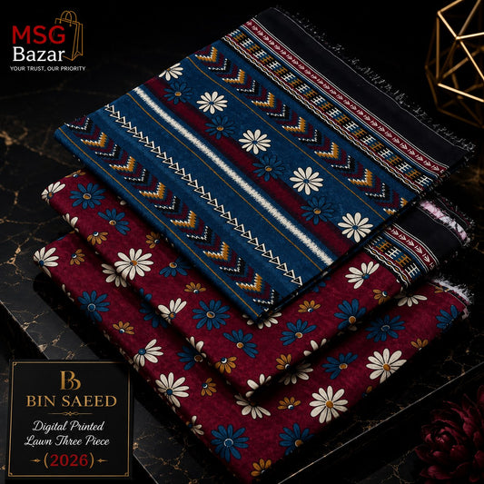 Three folded patterned fabric pieces stacked on a dark marble surface, with a black branded box at lower left. The top fabric is dark blue with white, yellow, and red geometric motifs; the middle is deep red with white and blue floral prints; the bottom is black with white and red geometric motifs.