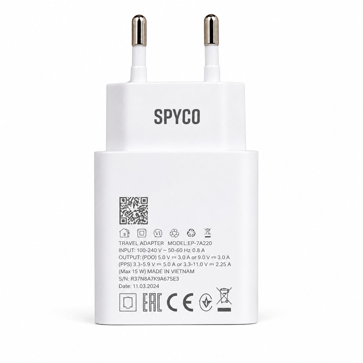 A white Spyco travel adapter plug with two metal pins, featuring printed specifications and certification logos on the back, set against a plain white background.