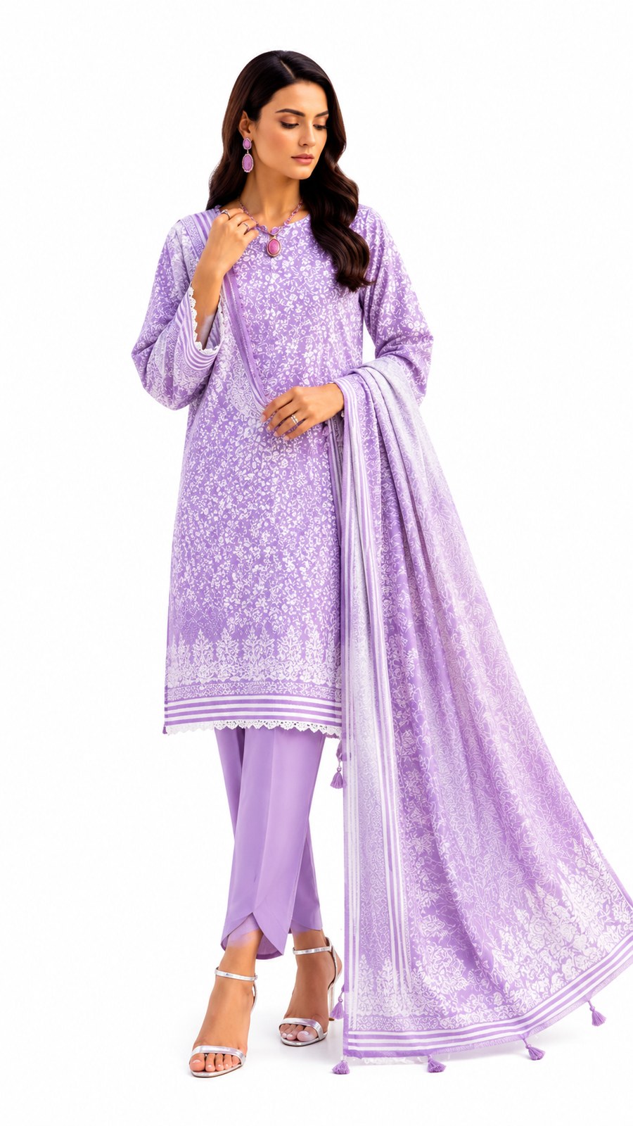 A woman modeling a lavender purple ethnic three-piece suit set with intricate white embroidery, matching trousers, and a sheer embroidered dupatta, set against a plain white background.