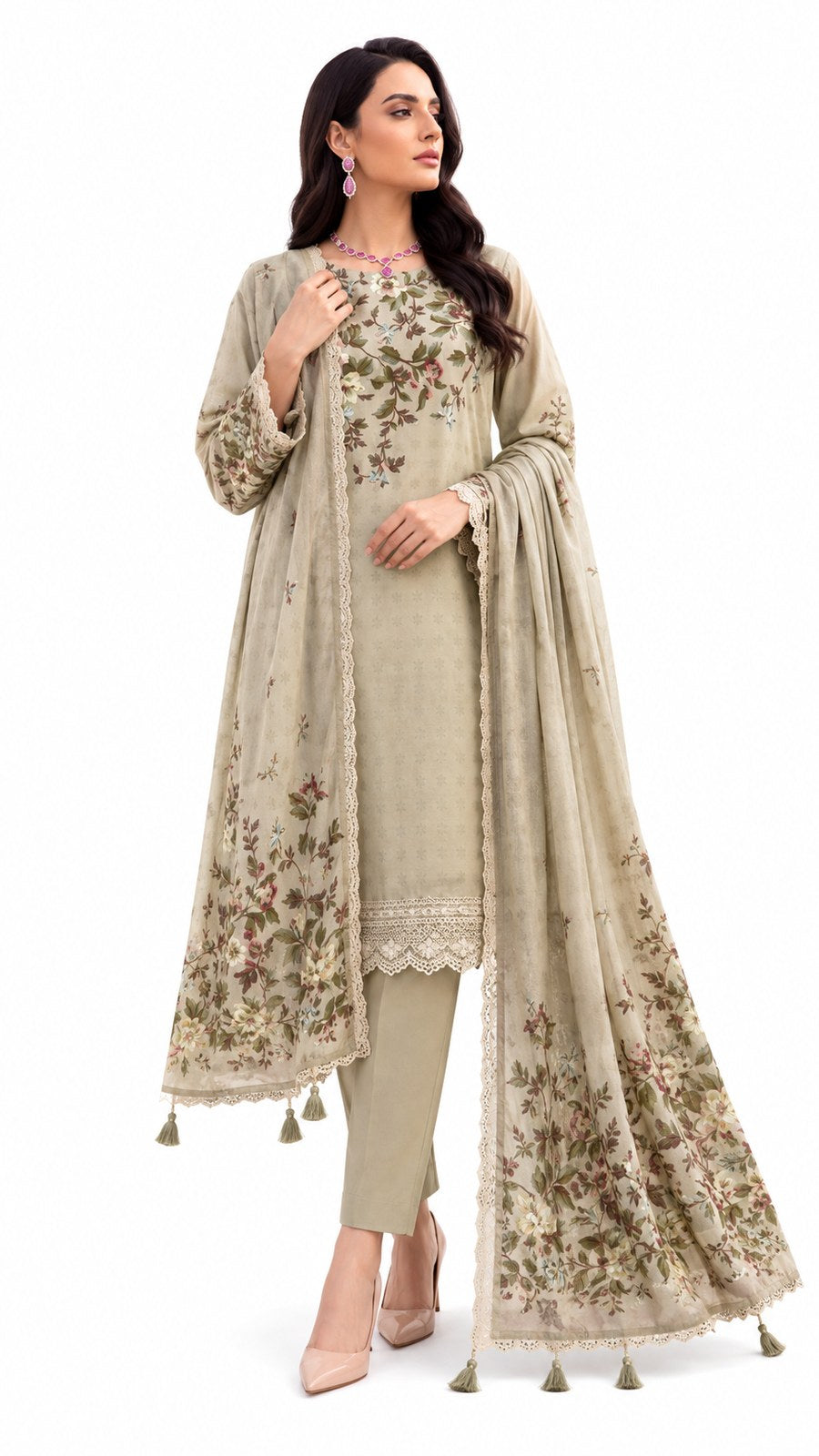 A woman modeling a traditional South Asian salwar kameez suit in a light beige/taupe color with floral embroidery and tassel details, paired with a matching dupatta, on a solid white background.