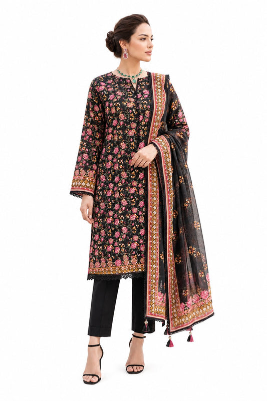 A woman modeling a traditional three-piece salwar kameez set in black, featuring a floral print with pink and gold accents, paired with black trousers and a matching printed dupatta.