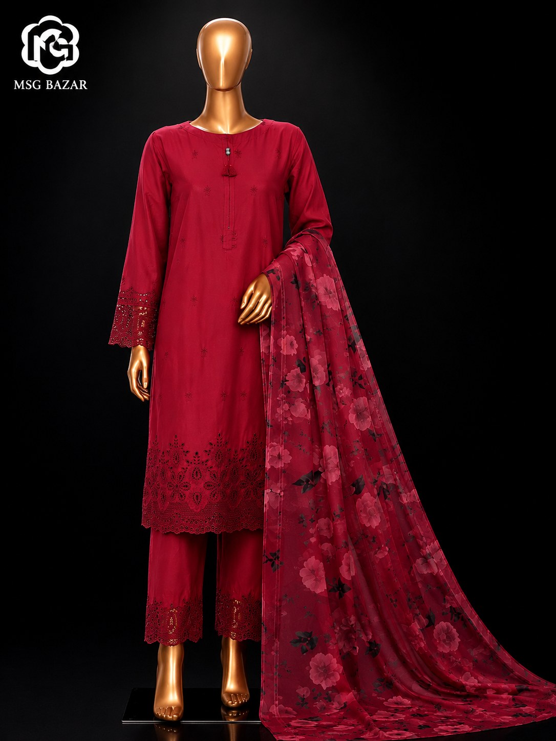 A three-piece deep red salwar kameez suit displayed on a gold mannequin against a black background, featuring a long-sleeve embroidered kurta, matching trousers, and a floral printed dupatta. The MSG BAZAR logo is visible in the top left corner.