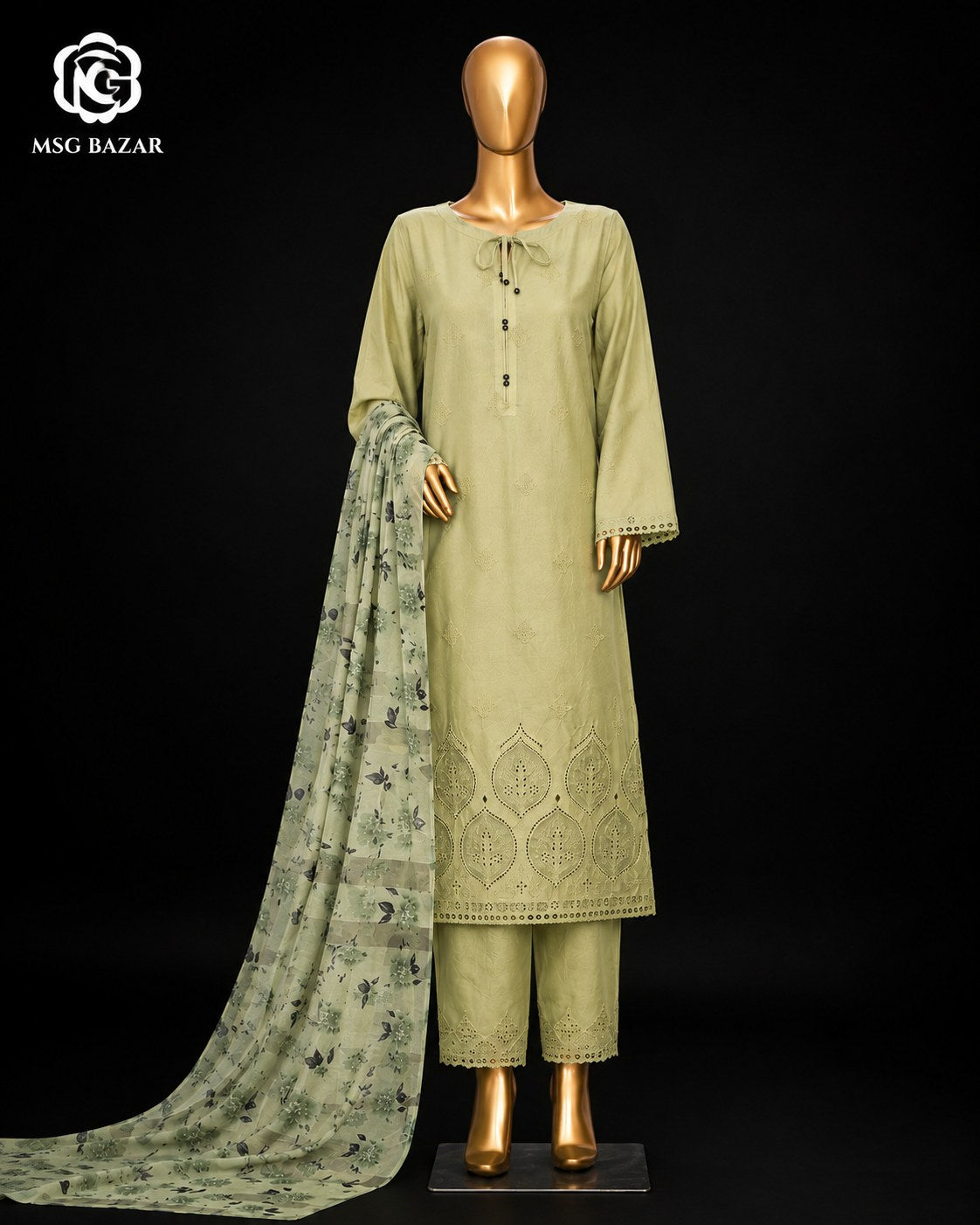 A three-piece olive green salwar kameez suit set displayed on a gold mannequin against a black background. The set includes a long-sleeved tunic with floral embroidery at the hem, matching trousers, and a patterned dupatta.